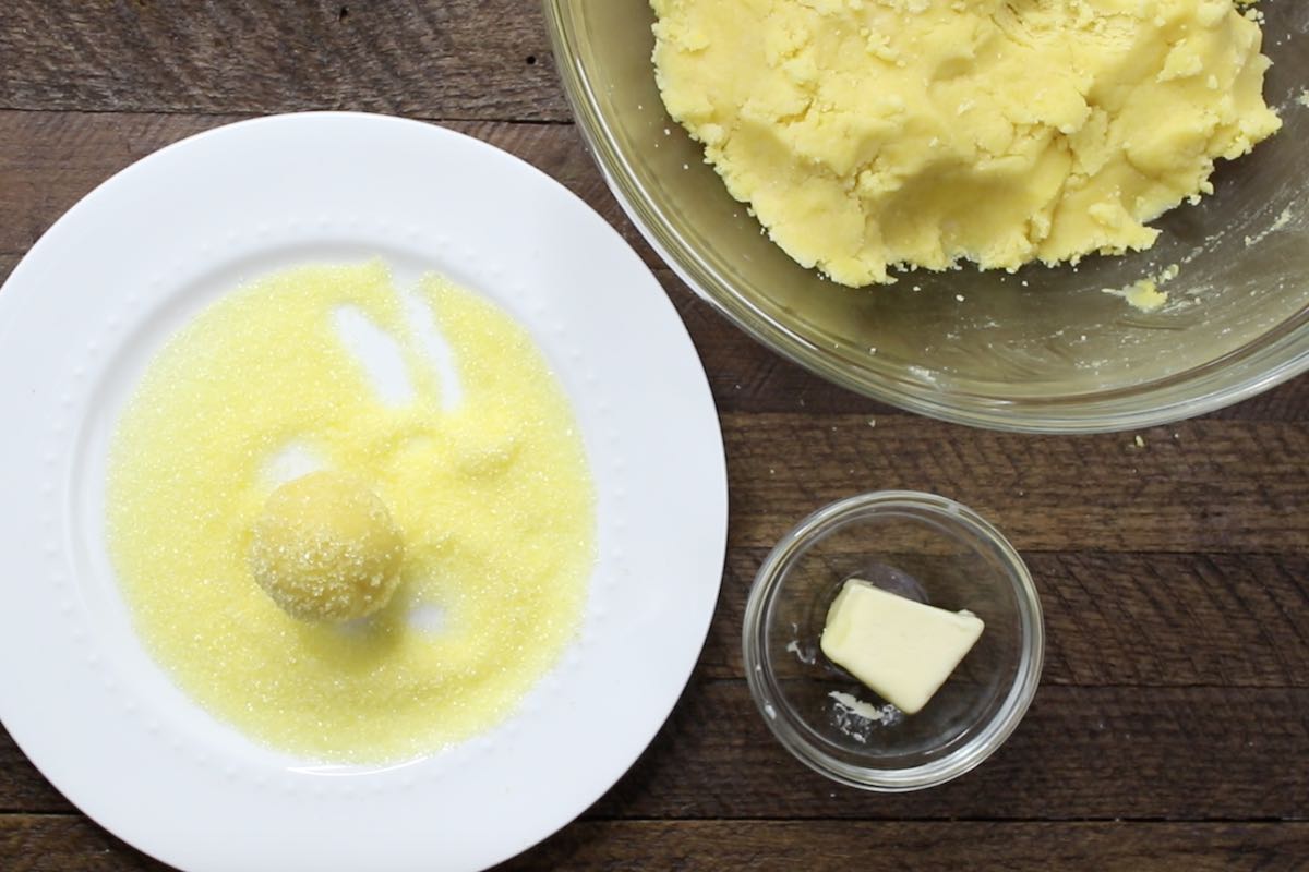 Coat the truffles with yellow sprinkles.