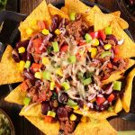 Learn how long to bake nachos so that they’re cheesy and crispy. Making them is simple and fun and by far, one of the most popular appetizers! However, if you don’t know some simple tricks to making them, your snack can turn soggy!