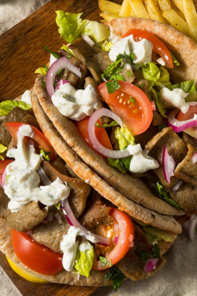 The gyro wrap has gyro meat, fresh vegetables, and feta cheese wrapped in warm pita bread. You can top it with Tzatziki sauce, and it’s the ultimate sandwich for Greek food lovers!